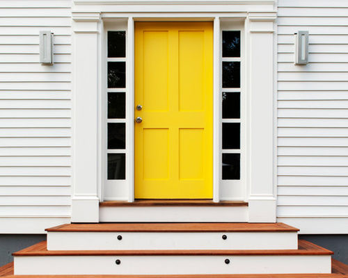 tiered stairway leading to bright yellow front exterior door