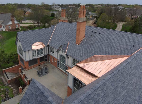 After living with a natural shake roof for years, these homeowners appreciate the easy care and curb appeal of their new ornamental composite slate roof.